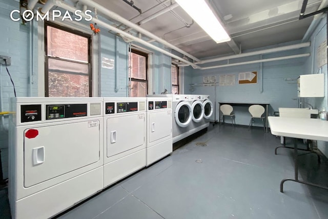 clothes washing area with sink and washer and dryer