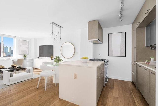 kitchen with high end stove, gray cabinetry, hanging light fixtures, light hardwood / wood-style floors, and track lighting