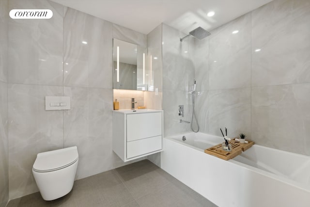 733 Ocean Pkwy Unit Ph9C, New York City, NY 11230 - full bath with tile walls, vanity, toilet, tile patterned floors, and washtub / shower combination