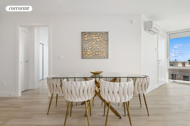 dining space featuring expansive windows, light wood-style flooring, a wall unit AC, visible vents, and baseboards
