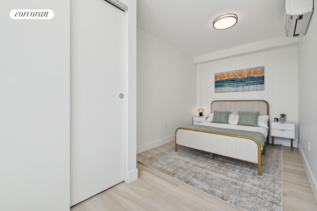 733 Ocean Pkwy Unit Ph9C, New York City, NY 11230 - bedroom featuring a wall mounted AC, wood finished floors, and baseboards