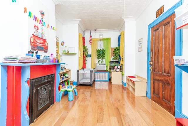 402 Fenimore St, New York City, NY 11225 - entryway with wood finished floors, crown molding, and a fireplace