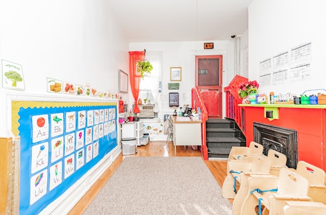 402 Fenimore St, New York City, NY 11225 - game room featuring wood finished floors and a fireplace