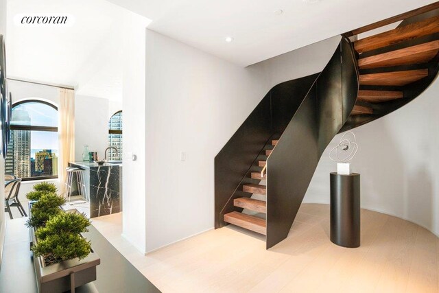 stairs featuring wood-type flooring