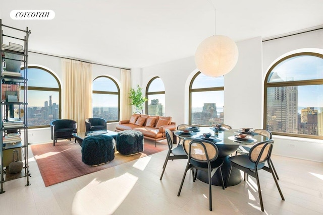 dining space featuring a view of city, plenty of natural light, and visible vents