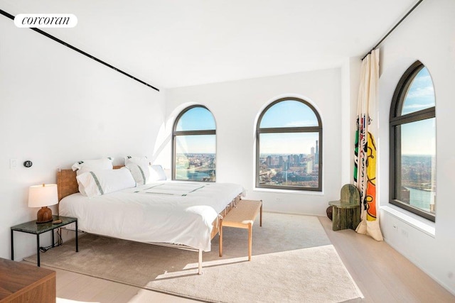 bedroom with light wood-style flooring and visible vents