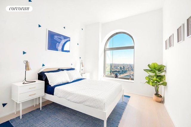 bedroom with visible vents and wood finished floors