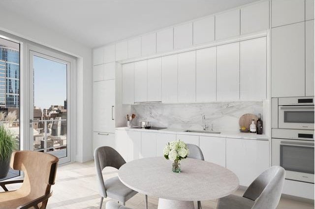 interior space with white cabinetry, sink, backsplash, and white double oven