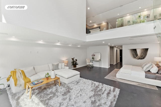 living area featuring recessed lighting, visible vents, a towering ceiling, and baseboards