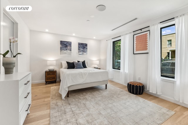 bedroom featuring light wood-style flooring, visible vents, baseboards, and recessed lighting