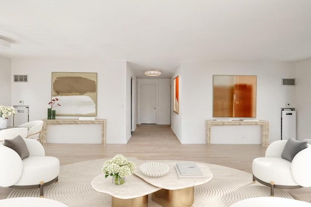 living room featuring visible vents and light wood finished floors