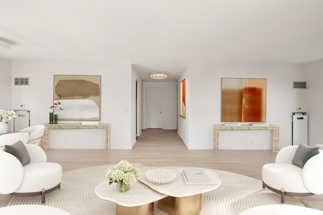 living room with visible vents and light wood-style floors