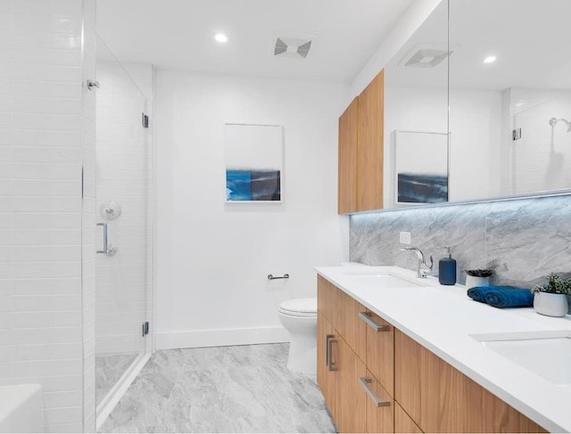 bathroom featuring tasteful backsplash, vanity, toilet, and an enclosed shower