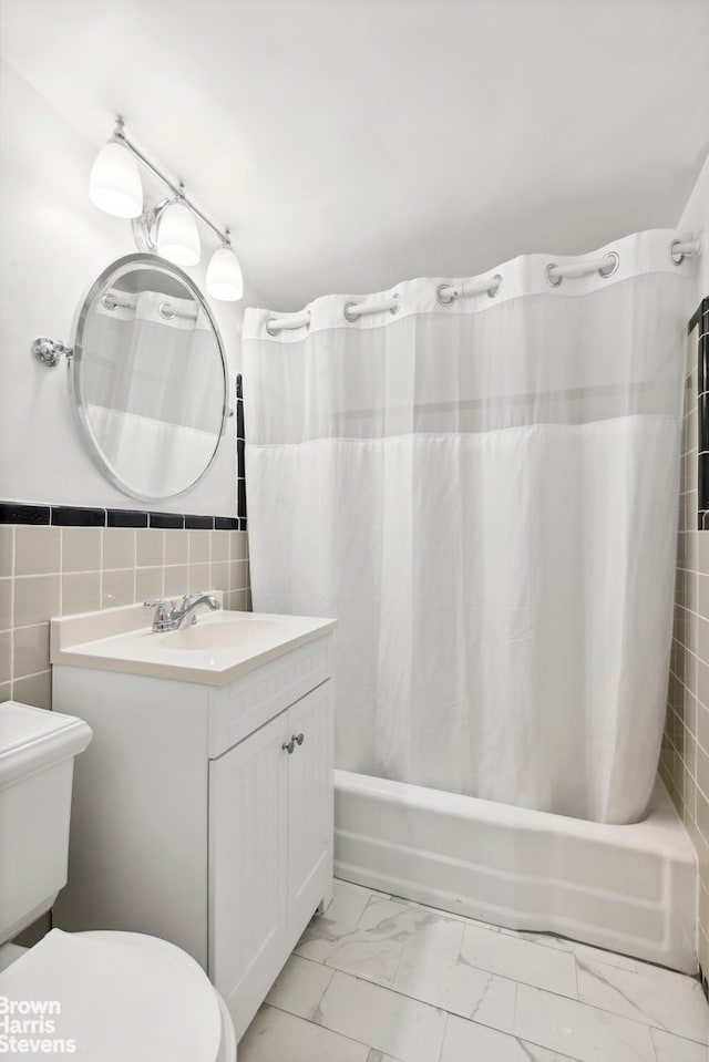 139 E 33rd St Unit 2C, New York City, NY 10016 - full bath with marble finish floors, vanity, shower / tub combo, and tile walls