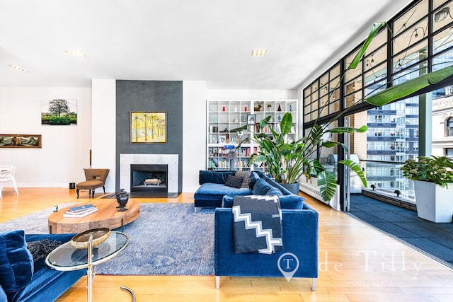 living room with a large fireplace and hardwood / wood-style floors