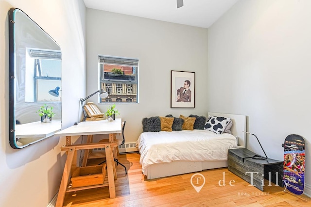 bedroom with ceiling fan and hardwood / wood-style floors