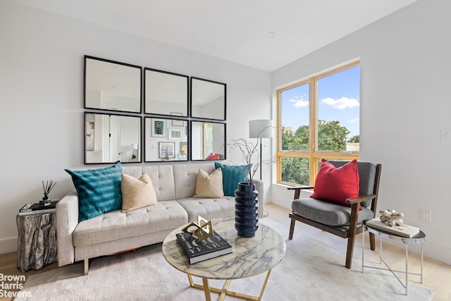 living area with wood finished floors and baseboards