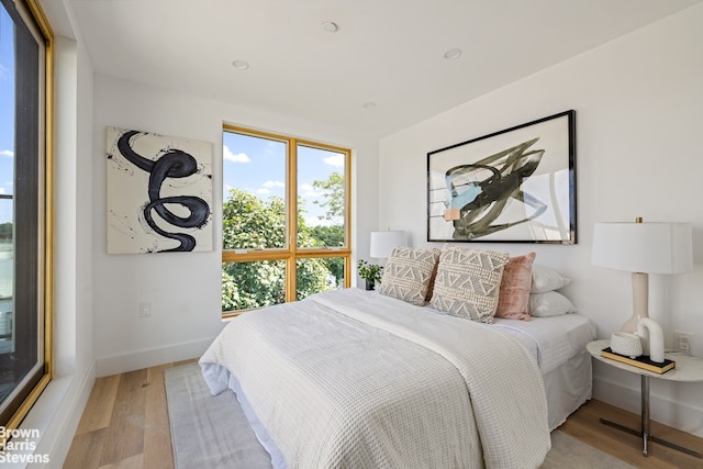 bedroom with light wood-style floors and baseboards