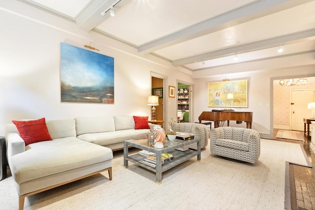 living room with beam ceiling, rail lighting, baseboards, and wood finished floors