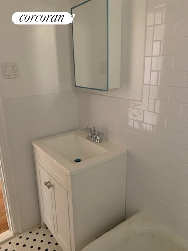 bathroom featuring tile walls and vanity