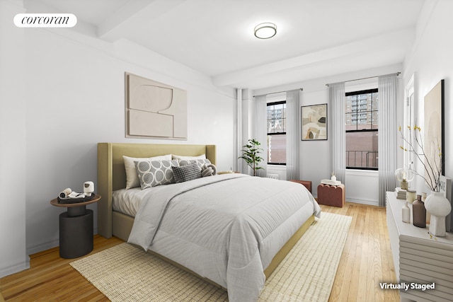 141 E 3rd St Unit 6B, New York City, NY 10009 - bedroom featuring light wood-style floors and beamed ceiling