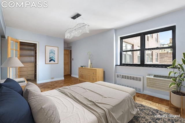 bedroom with radiator, parquet floors, and a chandelier