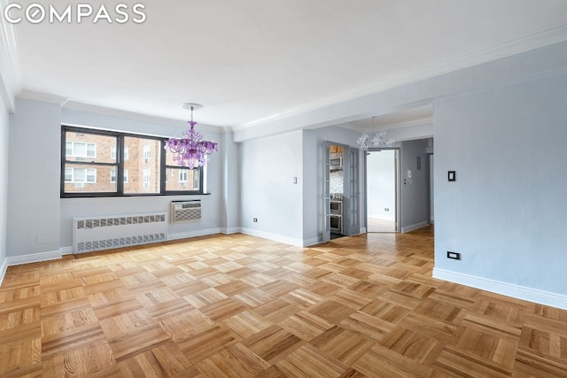 unfurnished living room featuring radiator, a chandelier, ornamental molding, and light parquet flooring