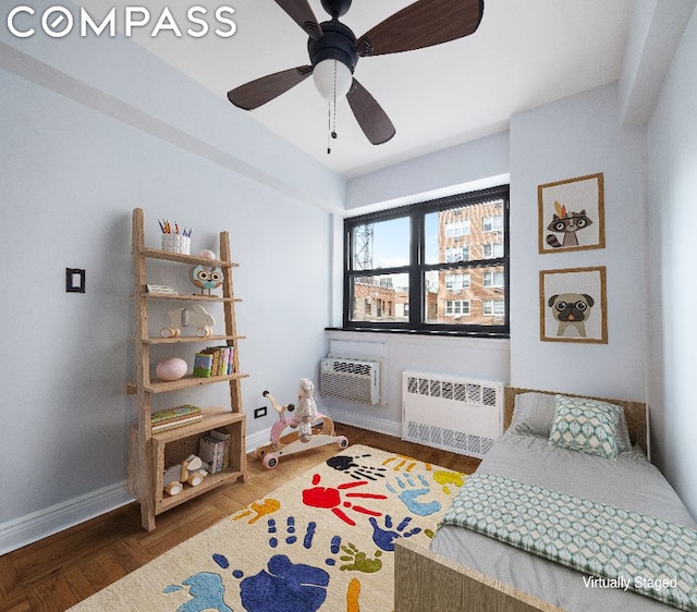 bedroom with radiator, ceiling fan, dark hardwood / wood-style floors, and an AC wall unit