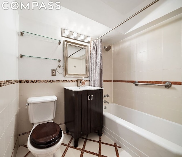 full bathroom featuring toilet, tile walls, shower / tub combo, and vanity