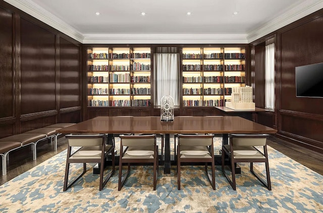 dining room with wood finished floors and crown molding