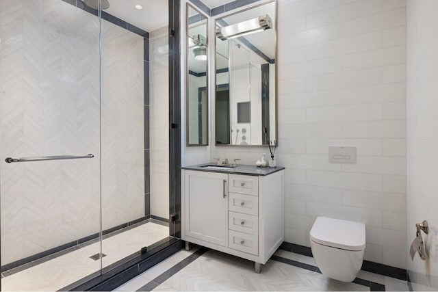 bathroom featuring a shower stall, toilet, vanity, and tile walls