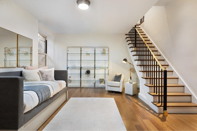 living room with stairs and wood finished floors