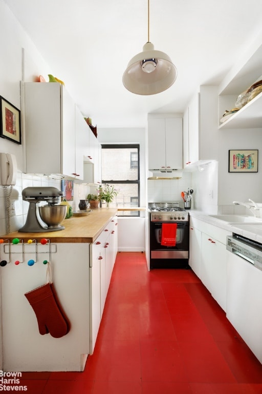 kitchen featuring sink, dishwasher, hanging light fixtures, stainless steel gas range oven, and white cabinets