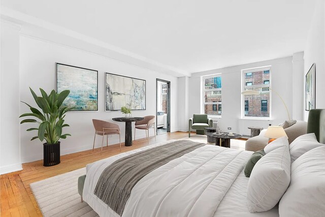 bedroom with baseboards and wood finished floors