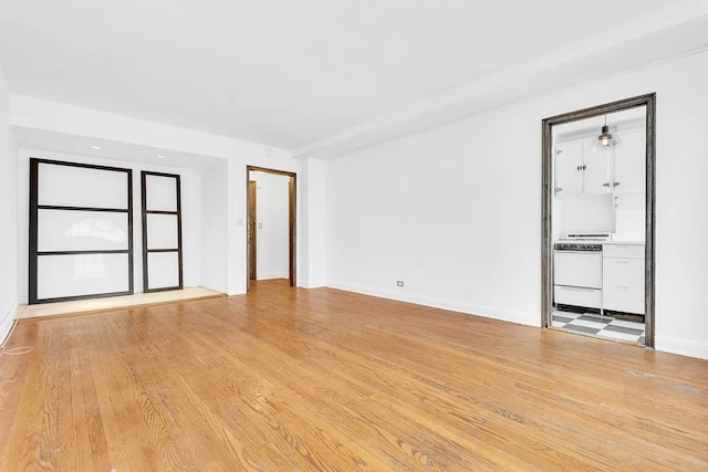 spare room featuring light hardwood / wood-style flooring