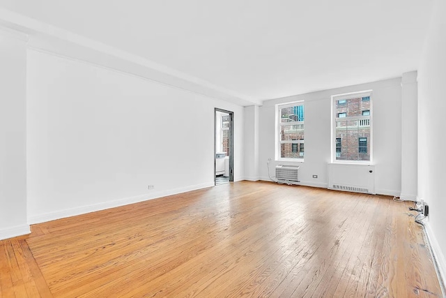 405 W 23rd St Unit 16I, New York City, NY 10011 - unfurnished room featuring light wood-type flooring and a wall mounted air conditioner