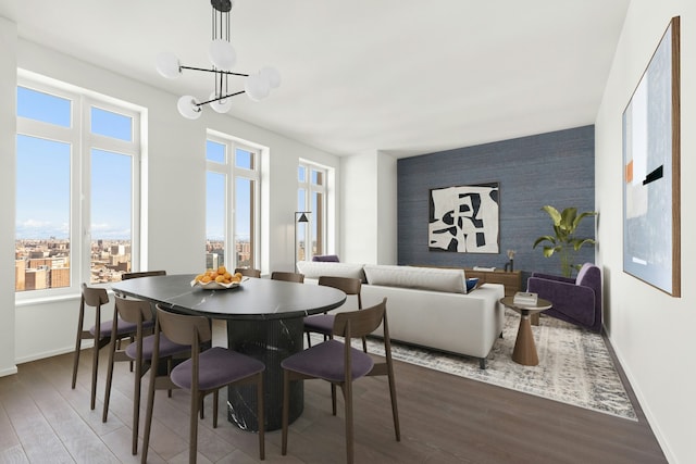 543 W 122nd St Unit 27A, New York City, NY 10027 - dining room featuring an accent wall, wood finished floors, and a chandelier