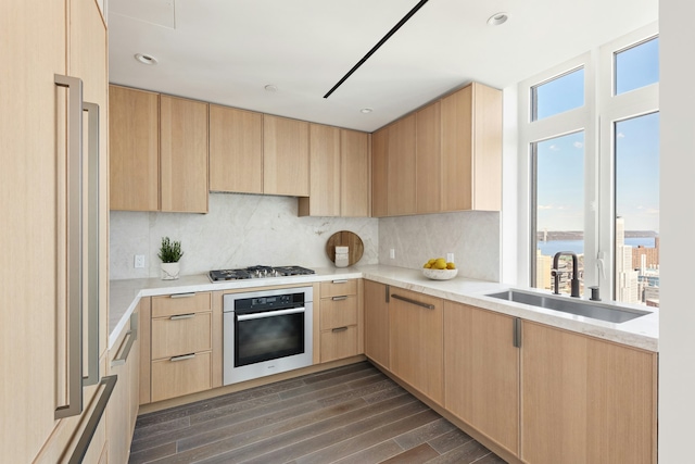 543 W 122nd St Unit 27A, New York City, NY 10027 - kitchen with stainless steel appliances, light brown cabinetry, dark wood-type flooring, backsplash, and recessed lighting