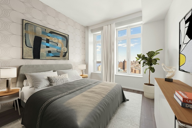 543 W 122nd St Unit 27A, New York City, NY 10027 - bedroom featuring wood finished floors, wallpapered walls, and an accent wall