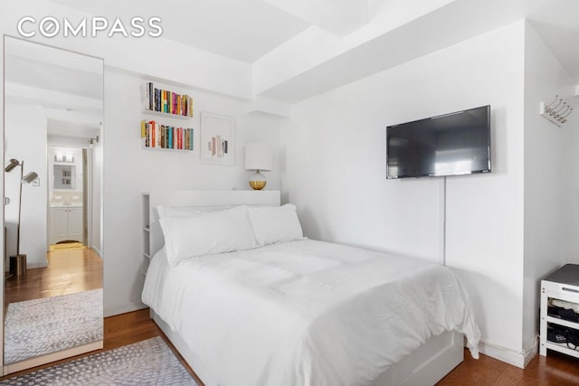 bedroom with dark hardwood / wood-style floors