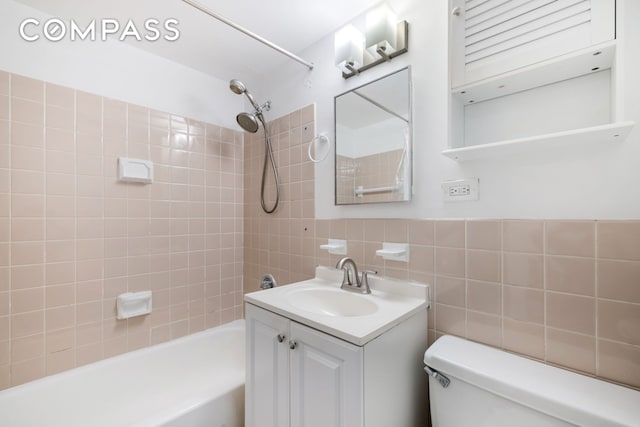 full bathroom featuring shower / tub combination, tile walls, toilet, and vanity