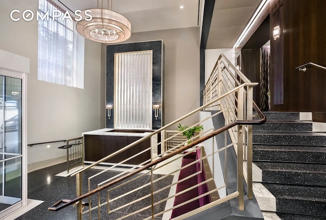 stairs with a chandelier