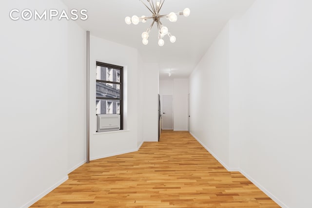 28 Perry St Unit 4E, New York City, NY 10014 - hallway featuring a chandelier, light wood finished floors, and baseboards
