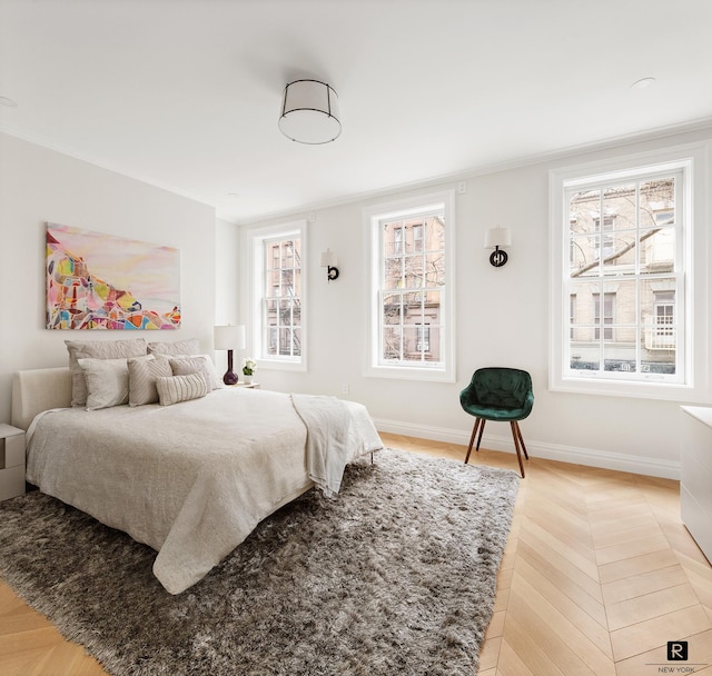 bedroom featuring crown molding and baseboards