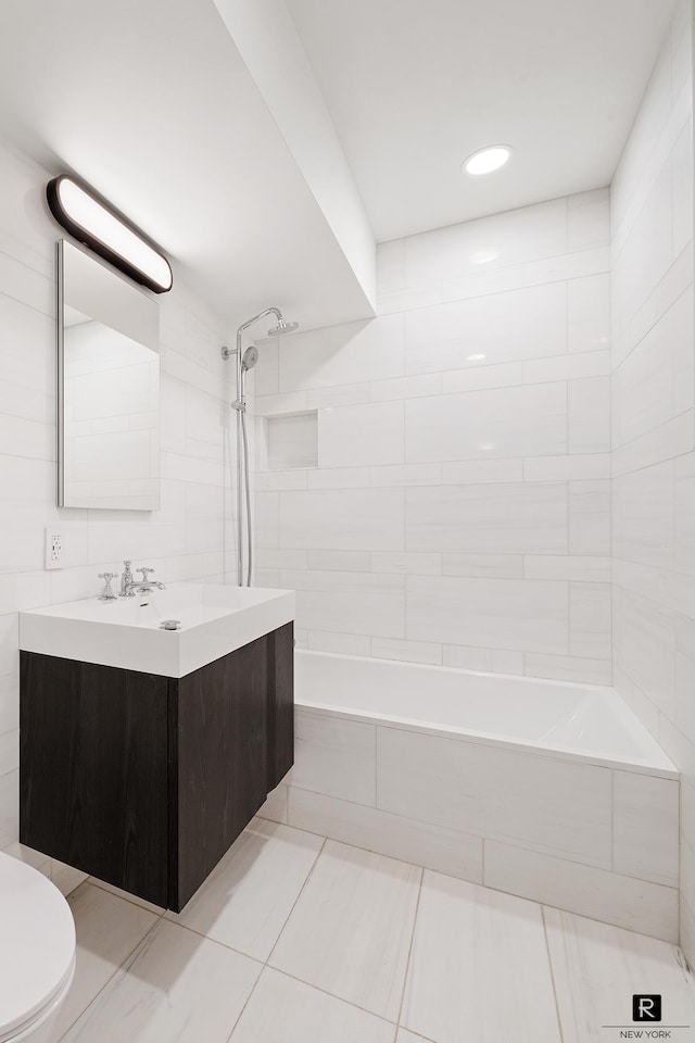 bathroom featuring tile walls, toilet, and vanity