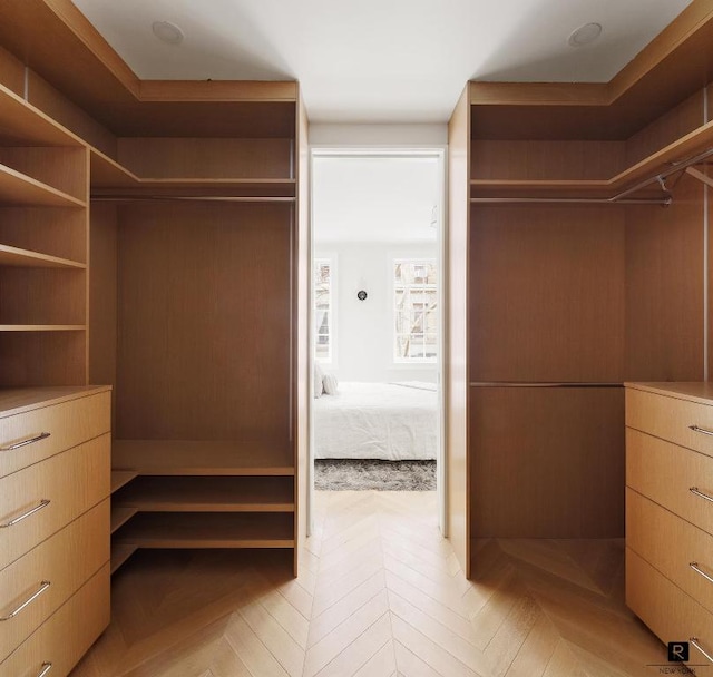 walk in closet featuring light parquet flooring