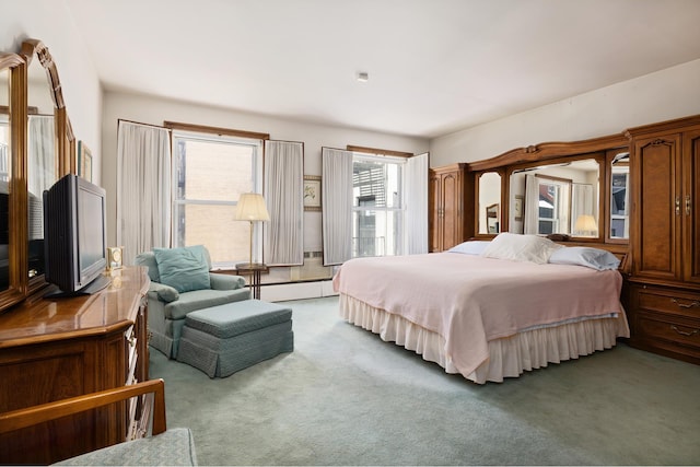 bedroom featuring baseboard heating and carpet