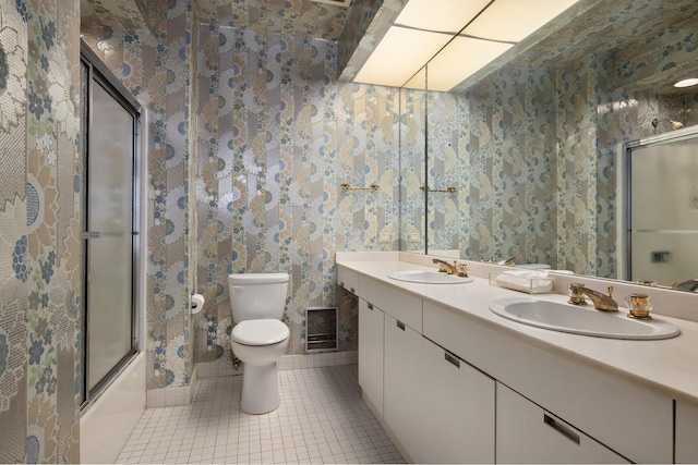 bathroom featuring tile patterned floors, a sink, toilet, and wallpapered walls