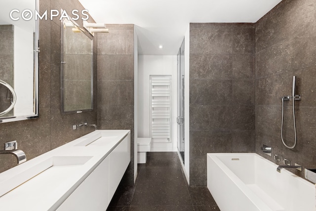 350 E 82nd St Unit 14Ab, New York City, NY 10028 - bathroom with tile walls, a bathtub, a shower, recessed lighting, and double vanity