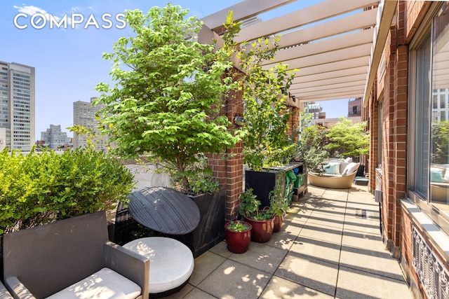 view of patio with a city view and a pergola